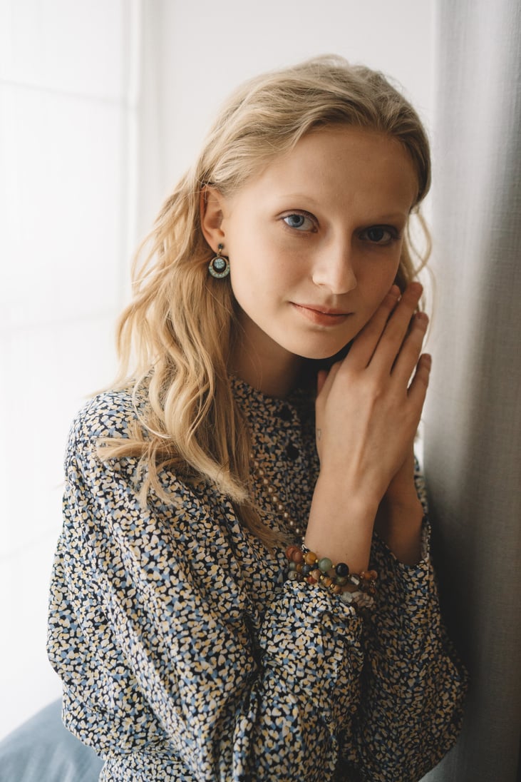 Photo of a Beautiful Woman Posing with Her Hands Together